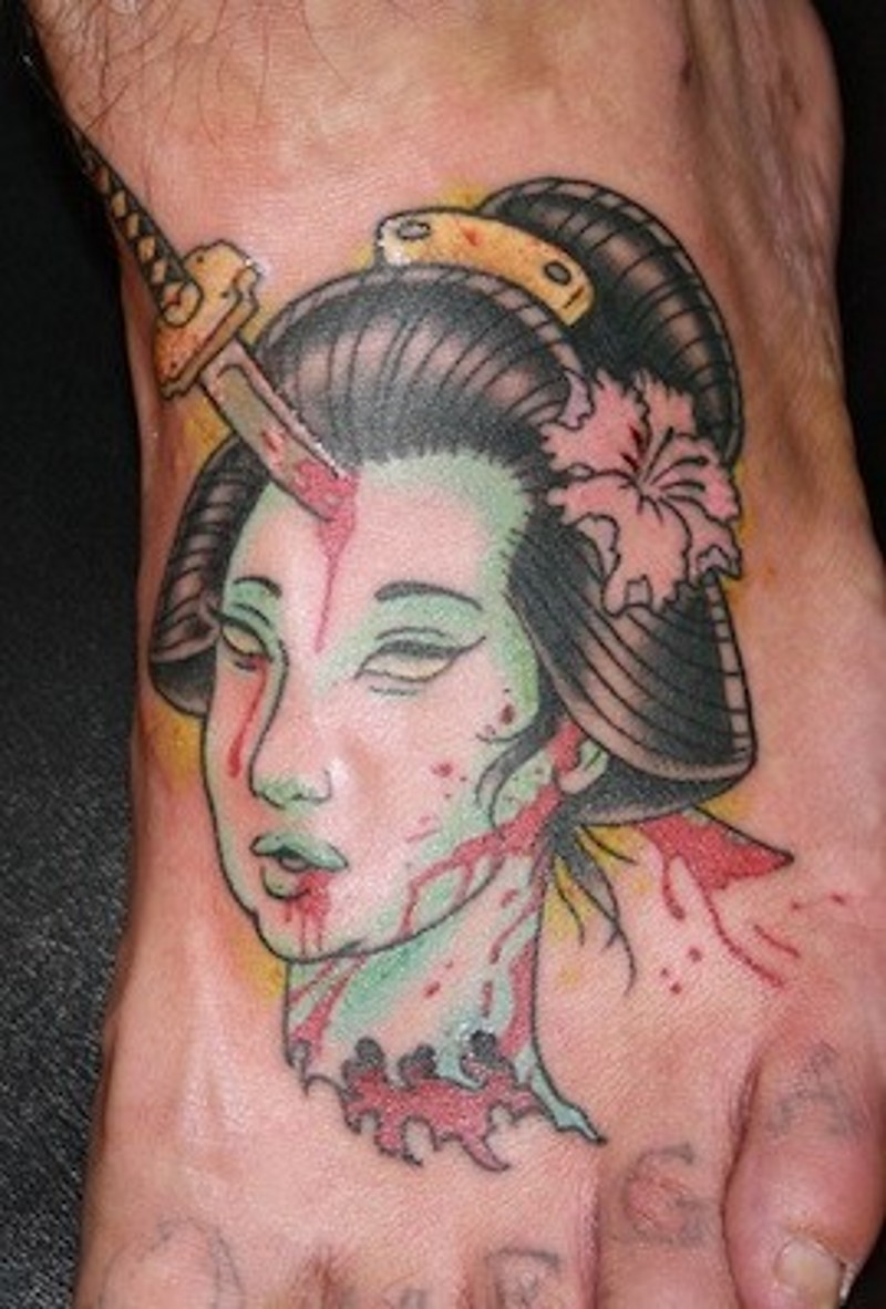 Homemade like old school colored foot tattoo of geisha severed head with katana sword in it