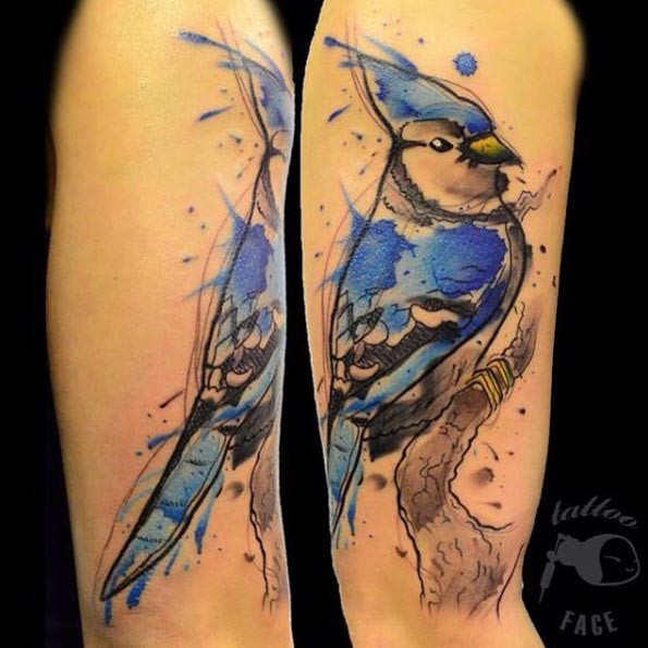 Homemade like watercolor style painted arm tattoo of beautiful bird