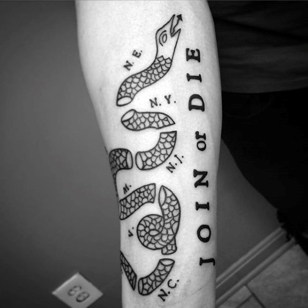 Homemade style black ink arm tattoo of join or die symbol with lettering
