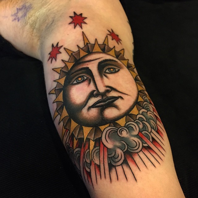 Homemade style colored biceps tattoo of sun with stars