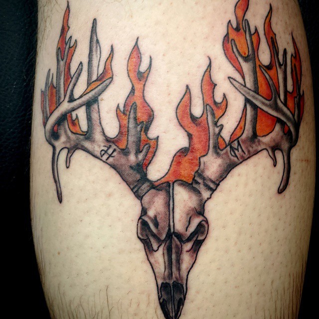 Homemade style colored big animal skull tattoo stylized with flames