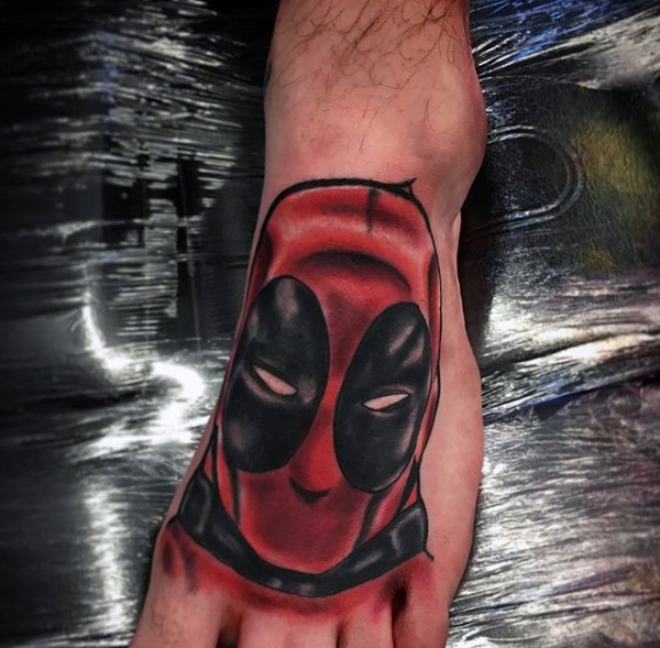 Homemade style colored foot tattoo of Deadpool head