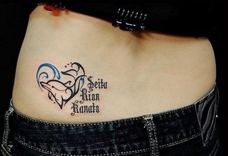 Homemade style colored little dolphin with lettering tattoo on hip