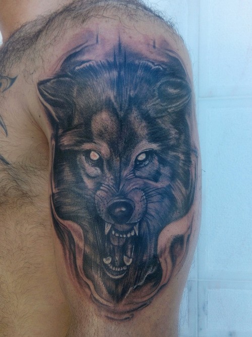 Homemade style colored shoulder tattoo of evil wolf head
