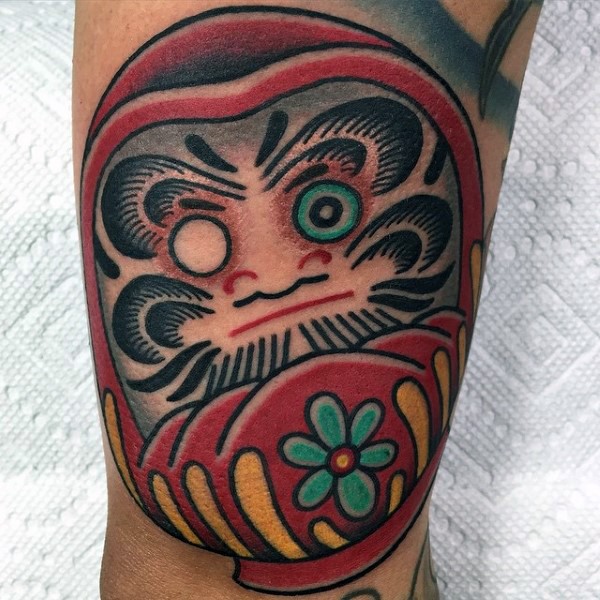 Homemade style colored tattoo of cute daruma doll with green flower