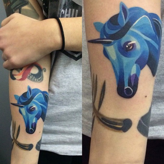 Homemade watercolor like blue unicorn tattoo on forearm