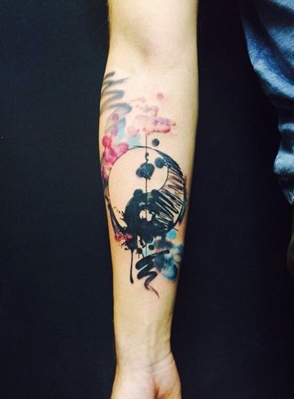 Homemade watercolor style forearm tattoo of Yin Yang symbol