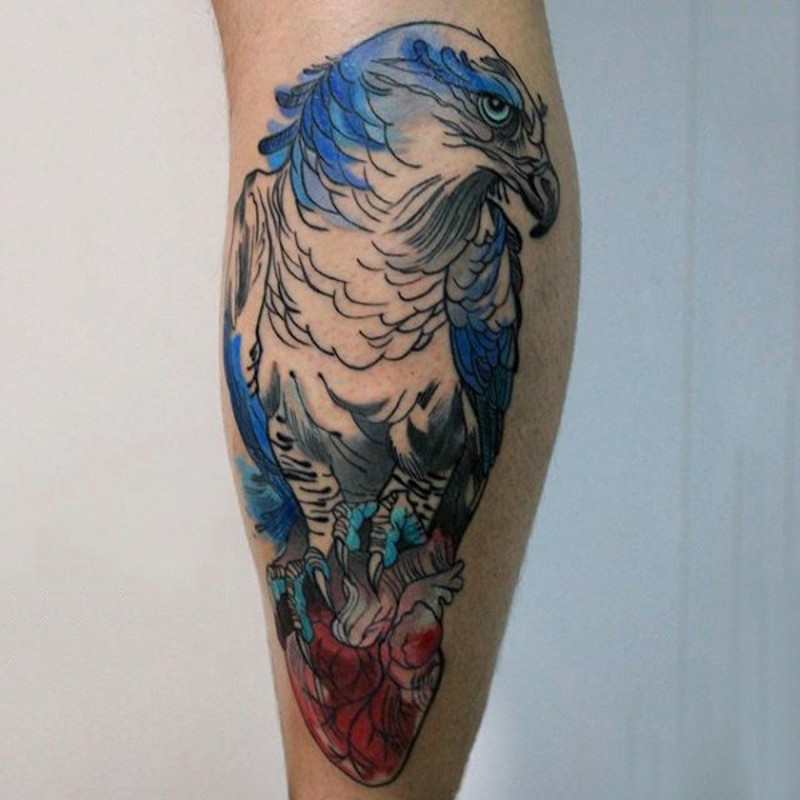 Homemade watercolor style painted leg tattoo of eagle with human heart