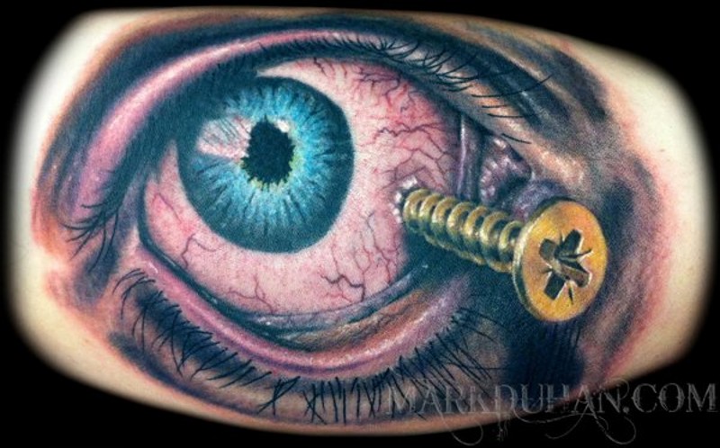 Horrifying painted colored eye with crew tattoo on leg