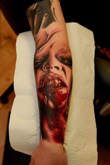 Horror movie like colored bloody  monster portrait forearm tattoo
