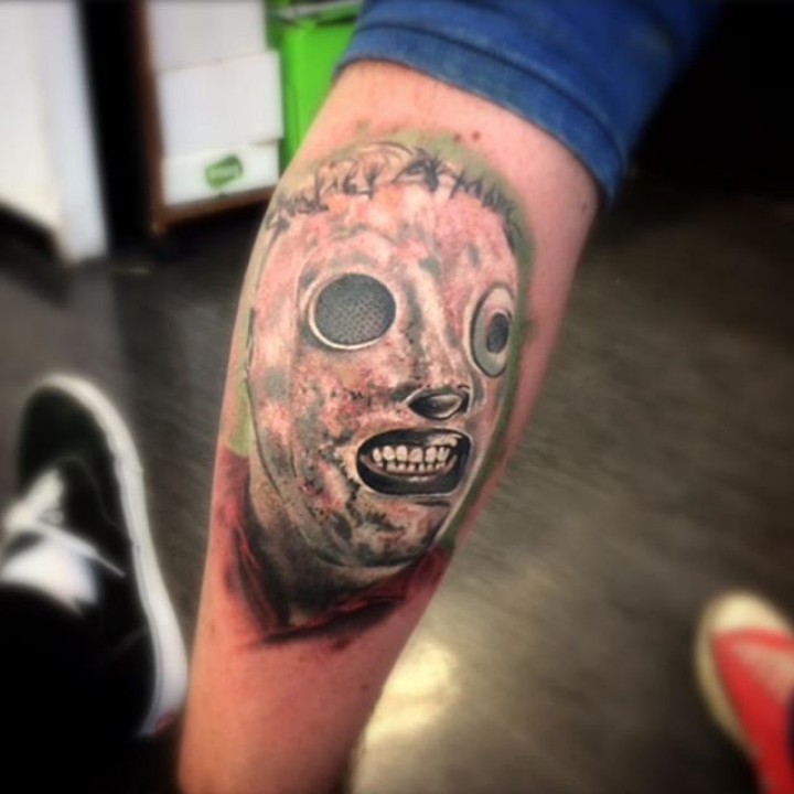 Horror movie masked monster face tattoo on leg