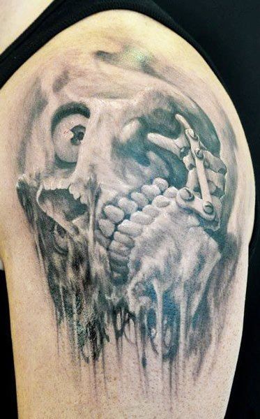 Horror movie style creepy corrupted skull tattoo on shoulder