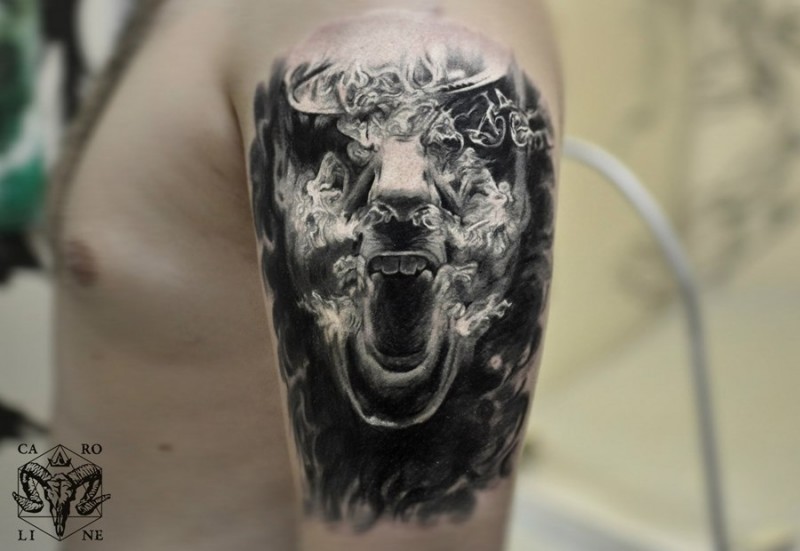 Horror style black ink shoulder tattoo of screaming face