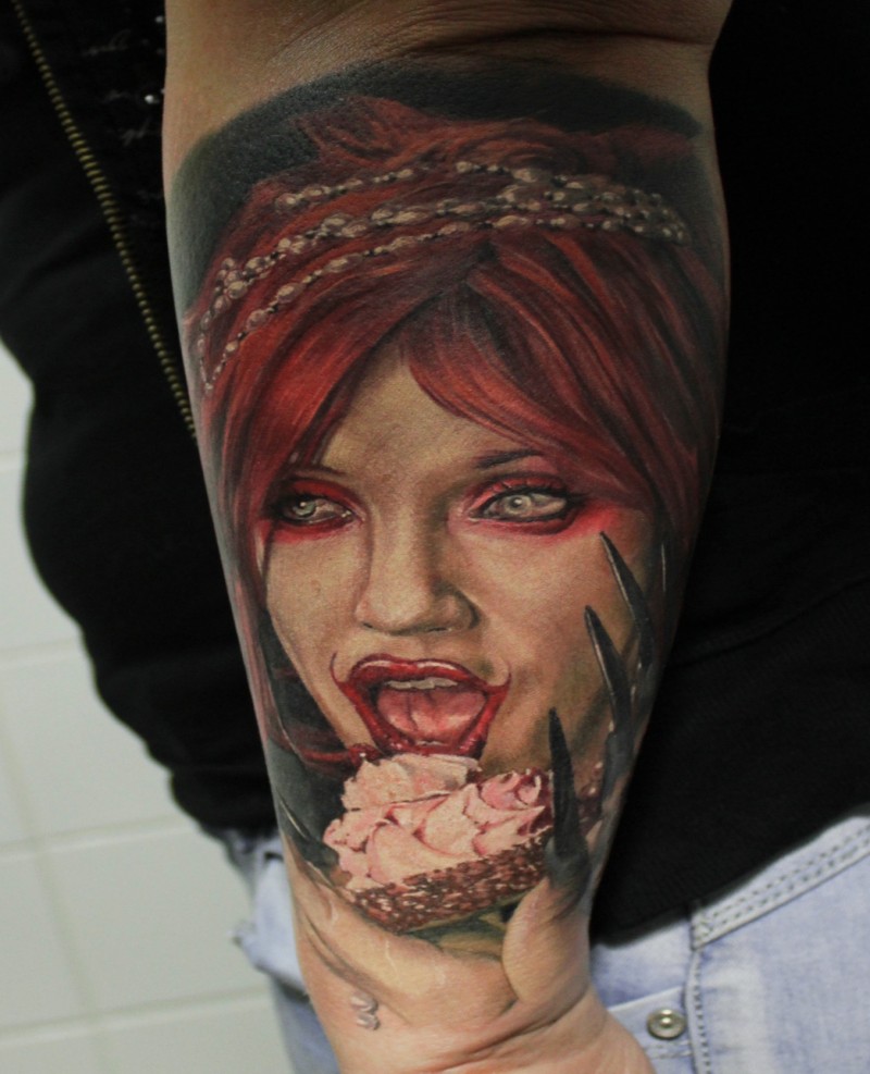 Horror style colored arm tattoo of creepy woman face with cup cake