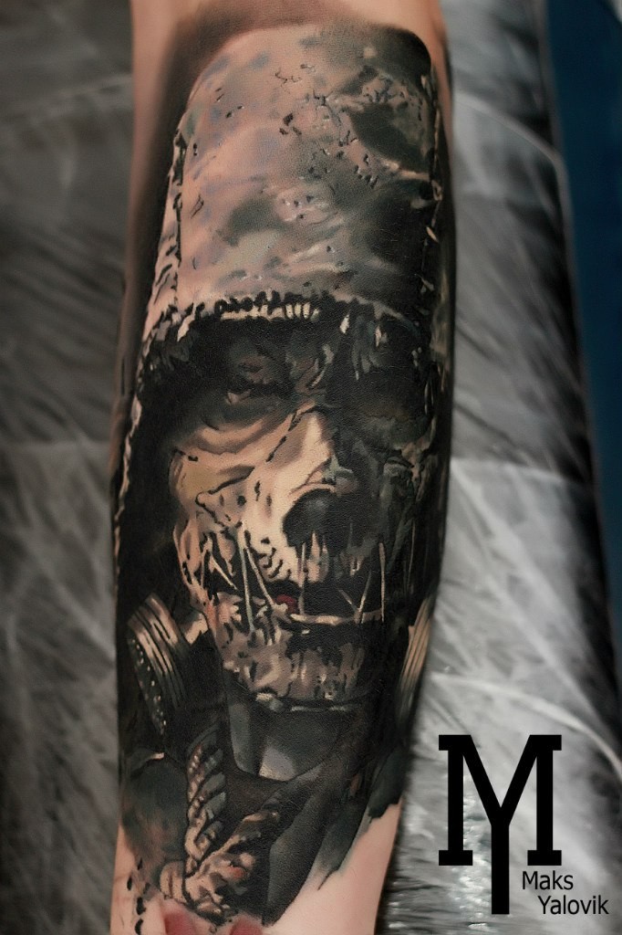 Horror style colored arm tattoo of evil maniac with gas mask