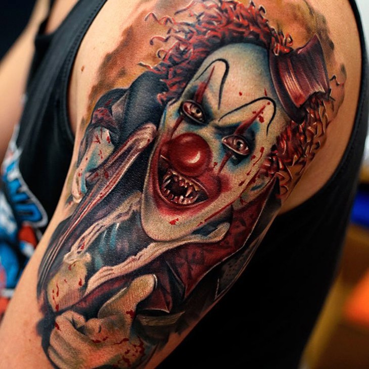Horror style colored shoulder tattoo of bloody clown monster