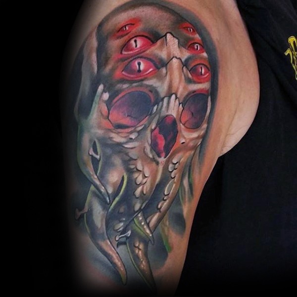 Horror style colored shoulder tattoo of demonic creepy head