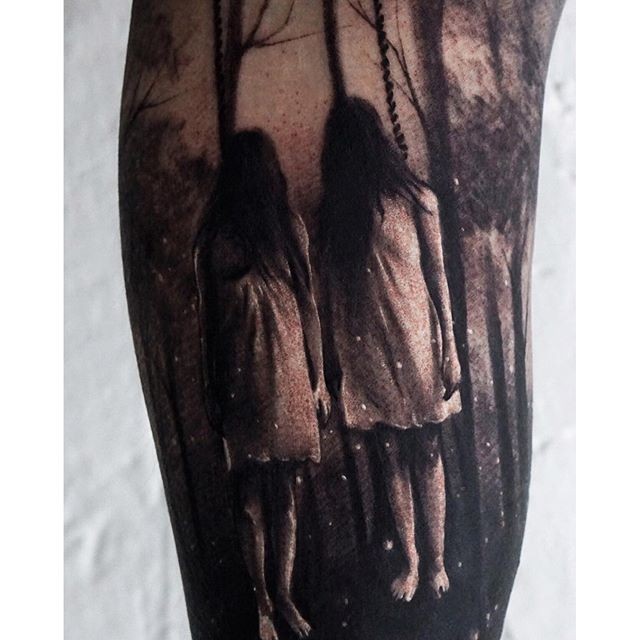 Horror style creepy looking sisters in forest tattoo on arm