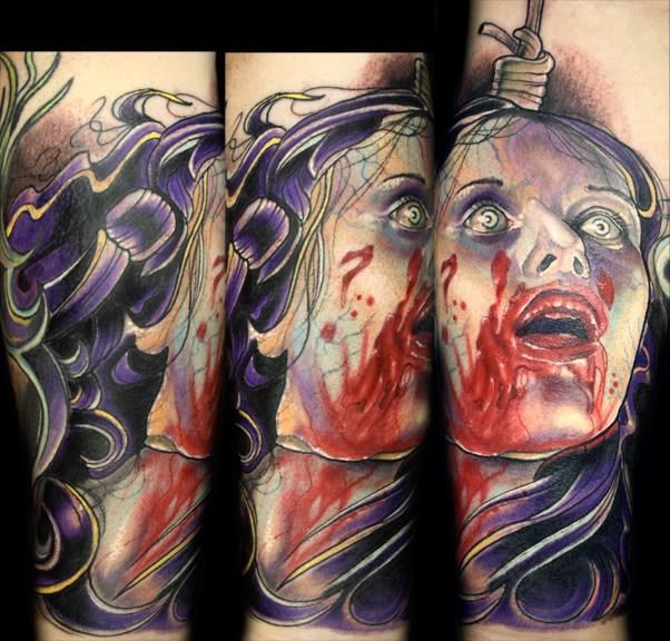 Horror style creepy looking tattoo of bloody woman head