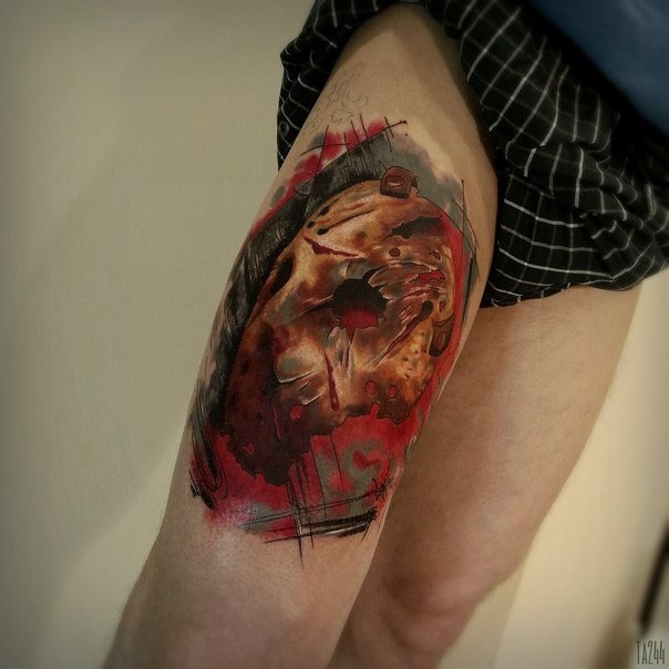 Horror style creepy looking thigh tattoo of evil mask