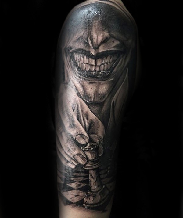 Horror style detailed arm tattoo of creepy man with chess board figure