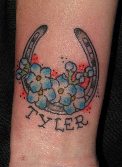 Horseshoe with blue flowers and name tattoo