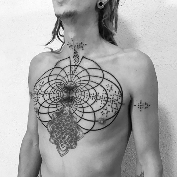 Hypnotic blackwork style chest tattoo of creative magical ornaments