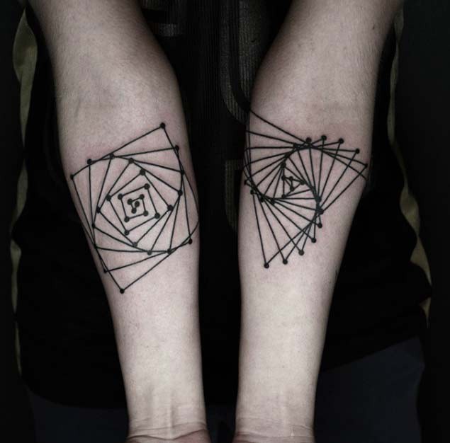 Hypnotic style black ink geometrical tattoo on forearms