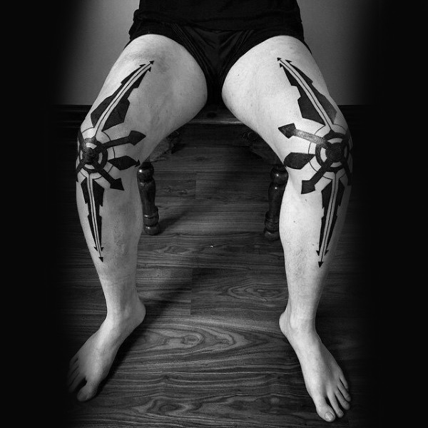Identic blackwork style large symbols tattoo on legs