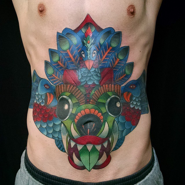 Illustrative colorful belly tattoo od demonic face with birds