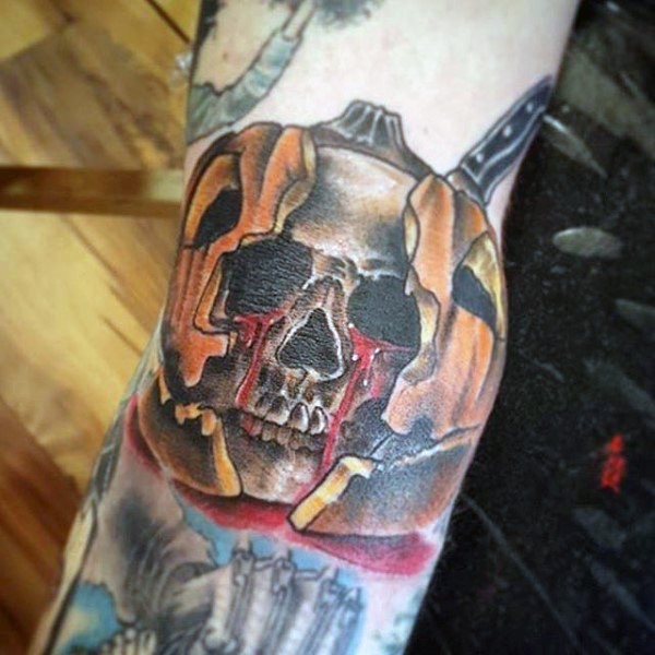 Illustrative style amazing looking bloody skull in pumpkin tattoo on arm
