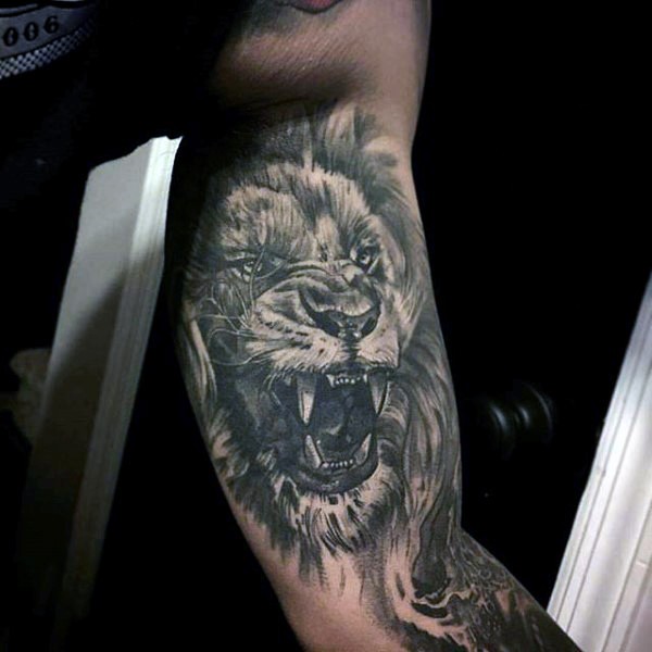 Illustrative style black and white roaring lion tattoo on biceps