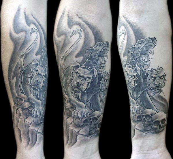 Illustrative style black ink arm tattoo of Cerberus with human skulls