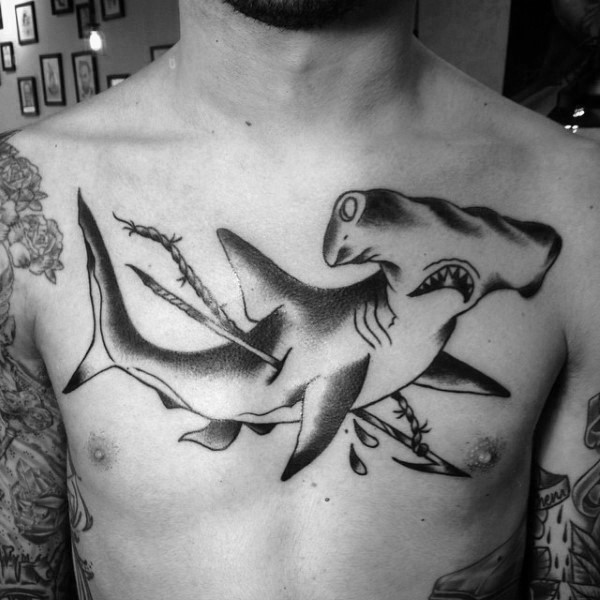 Illustrative style black ink chest tattoo of harpooned hammerhead shark