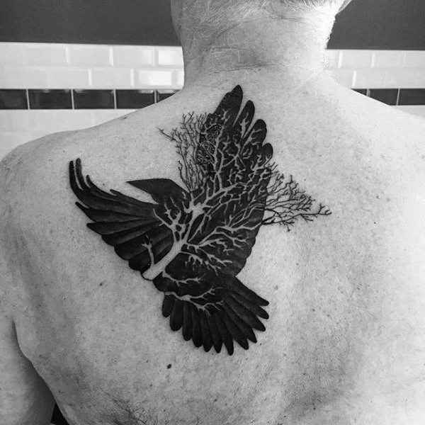 Illustrative style black ink scapular tattoo of dark crow with tree branch