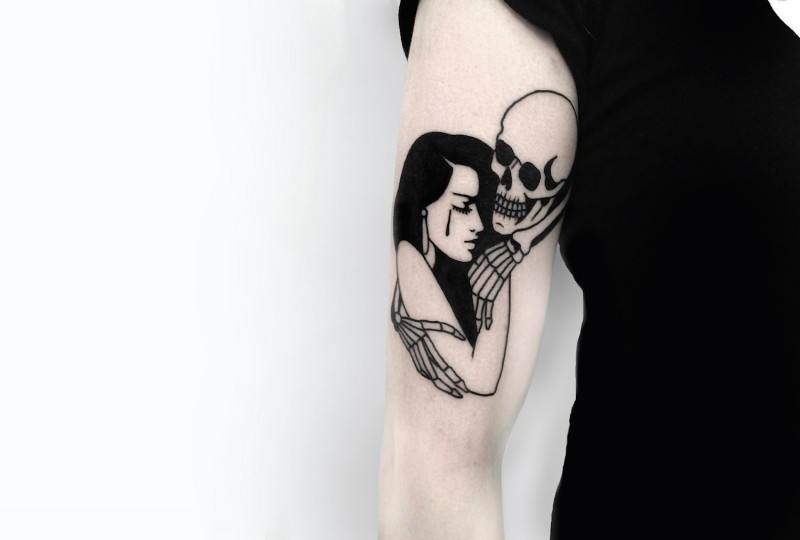 Illustrative style black ink shoulder tattoo of woman with skeleton