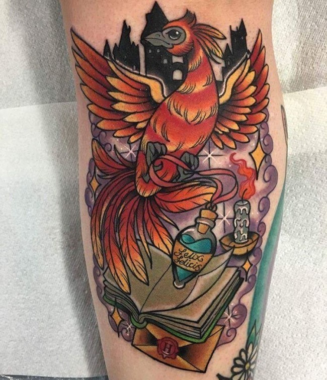 Illustrative style colored arm tattoo of phoenix bird with magic potion and book