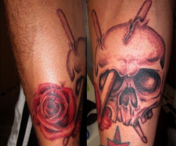 Illustrative style colored arm tattoo of human skull with drum sticks