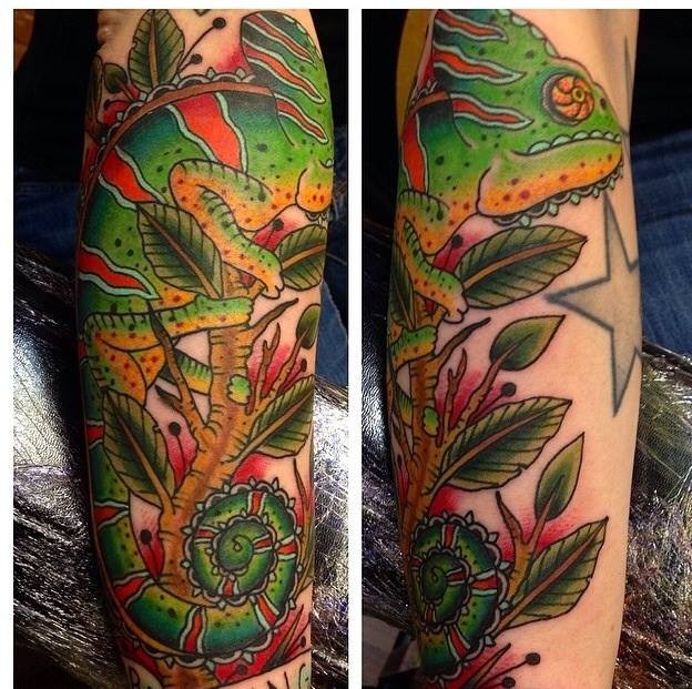 Illustrative style colored arm tattoo of cool looking chameleon