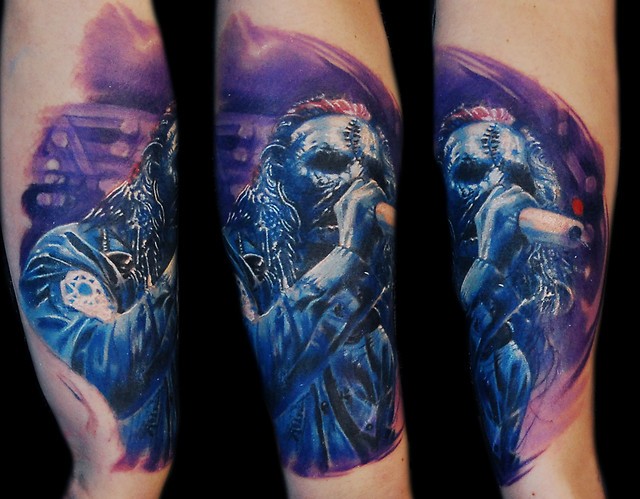 illustrative style colored arm tattoo of famous rock singer