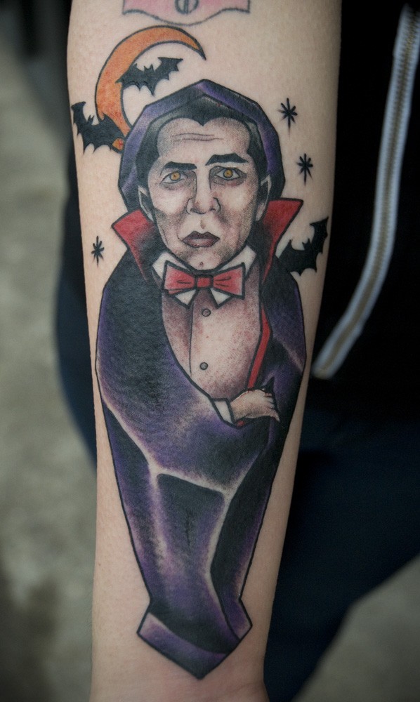 Illustrative style colored arm tattoo of Dracula with bats