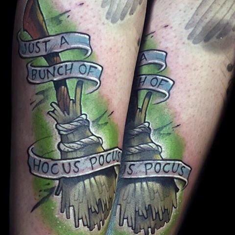 Illustrative style colored arm tattoo of witch broom and lettering