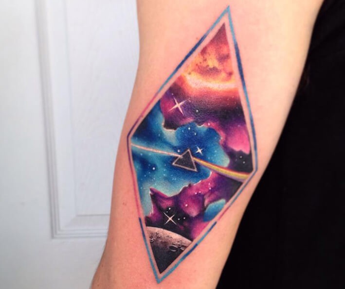 Illustrative style colored arm tattoo stylized with space