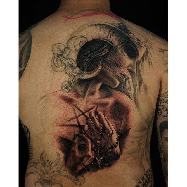 Illustrative style colored back tattoo of demonic woman with devils cross