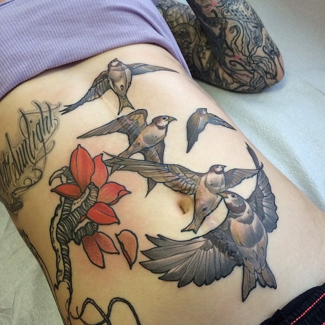 Illustrative style colored belly tattoo of flying birds and flower