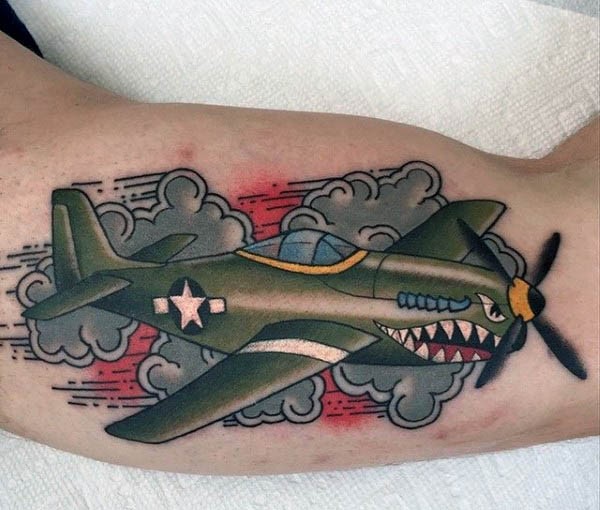 Illustrative style colored biceps tattoo of fighter plane