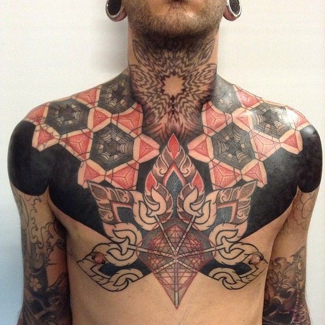 Illustrative style colored chest and shoulder tattoo of various ornaments