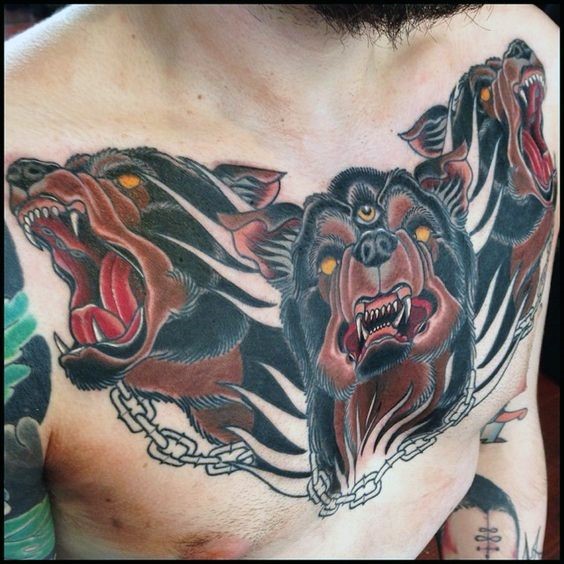 Illustrative style colored chest tattoo of Cerberus head with chain