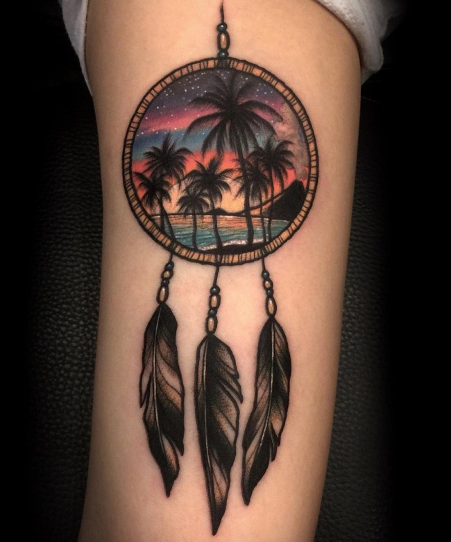 Illustrative style colored dream catcher tattoo on arm