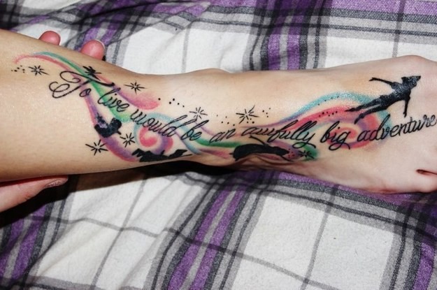 Illustrative style colored foot tattoo of Peter Pan and lettering